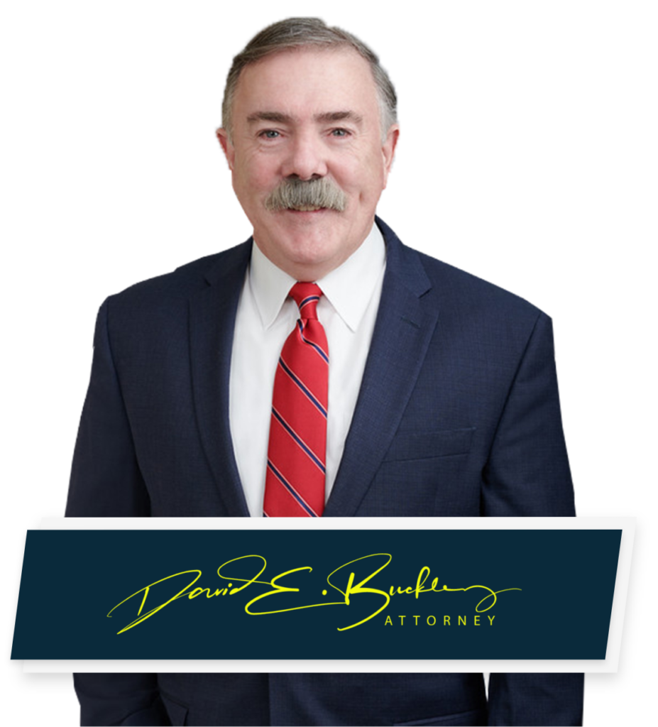 Amherst Personal Injury Lawyer Dave Buckley poses for headshot with signature below